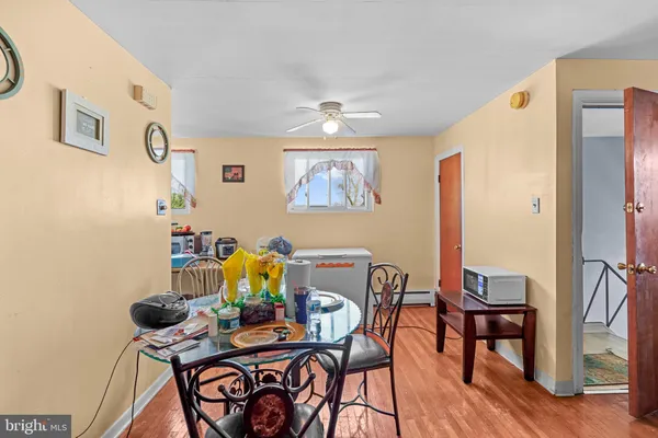 a view of a dining room with furniture and wooden floor