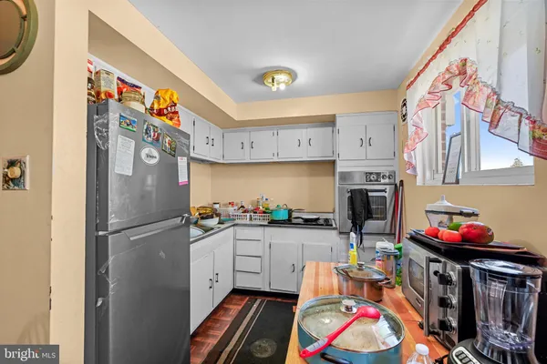 a kitchen with stainless steel appliances a chimney and a refrigerator