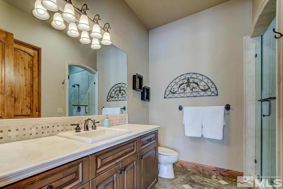 3255 Kinney Court Reno, NV 89511 - Photo 19 of 38 a bathroom with a sink a toilet and a mirror