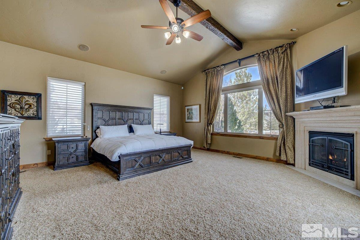 3255 Kinney Court Reno, NV 89511 - Photo 21 of 38 a spacious bedroom with a bed fireplace and window