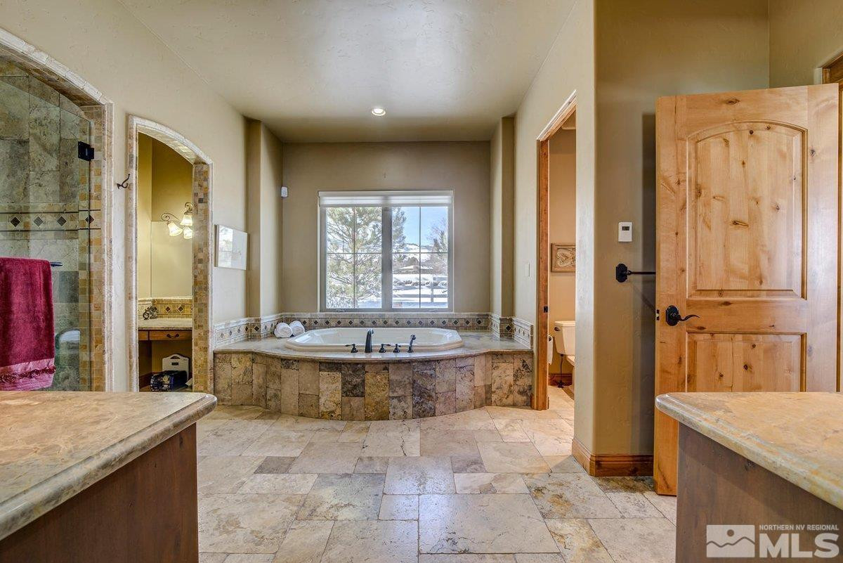 3255 Kinney Court Reno, NV 89511 - Photo 23 of 38 a large spacious bathroom with a granite countertop tub shower and sink