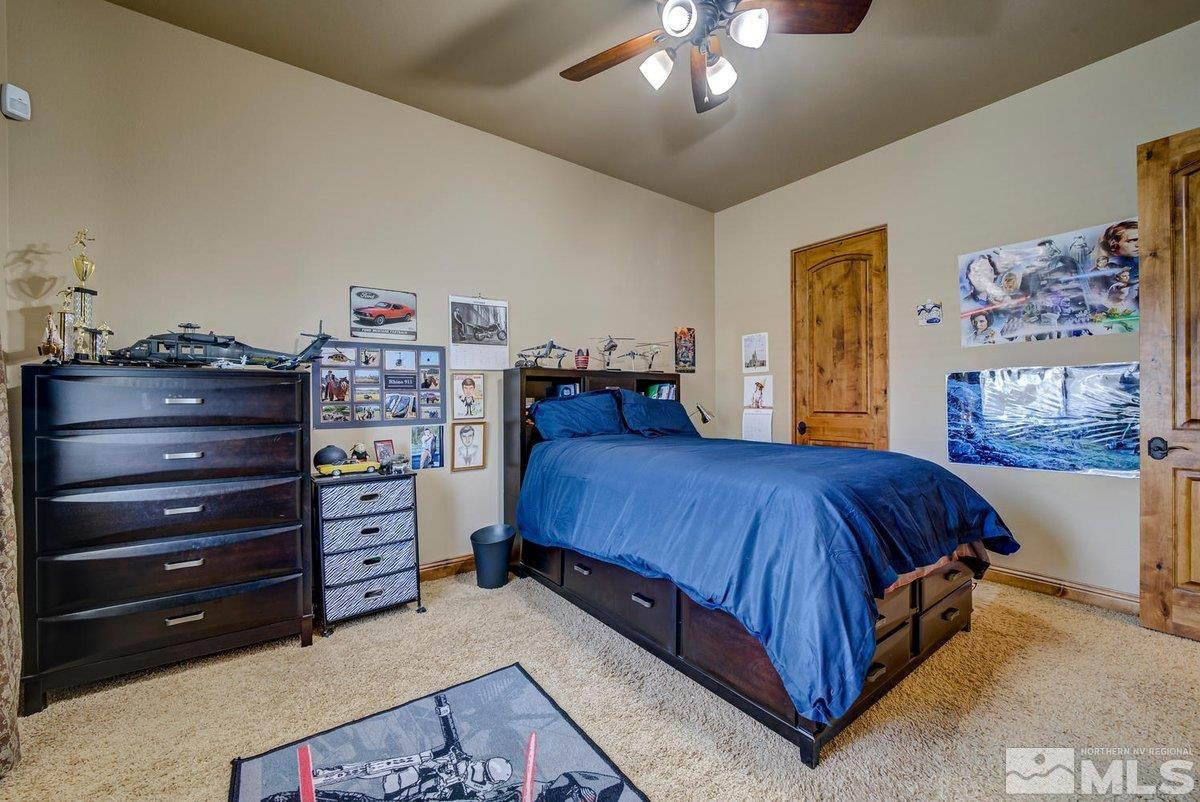 3255 Kinney Court Reno, NV 89511 - Photo 25 of 38 a bedroom with a bed and a chandelier