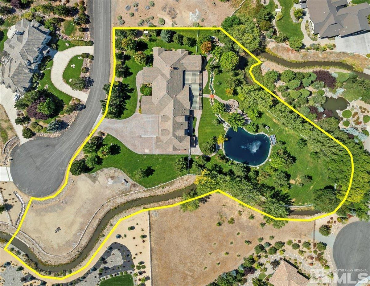 3255 Kinney Court Reno, NV 89511 - Photo 27 of 38 an aerial view of a house with a yard and large trees