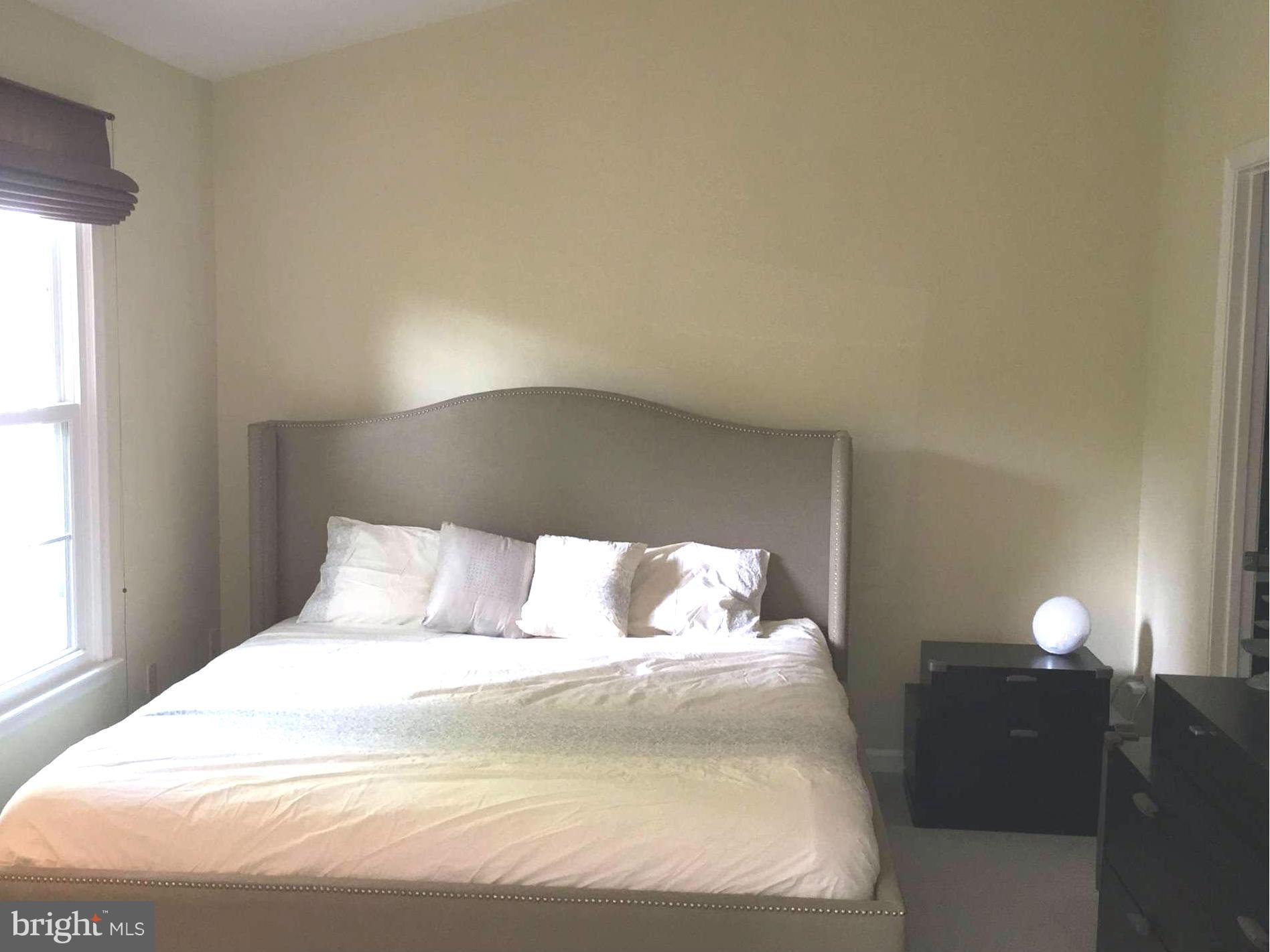 2617 Chivalry Court Silver Spring, MD 20902 - Photo 13 of 20 a bedroom with a bed and a window