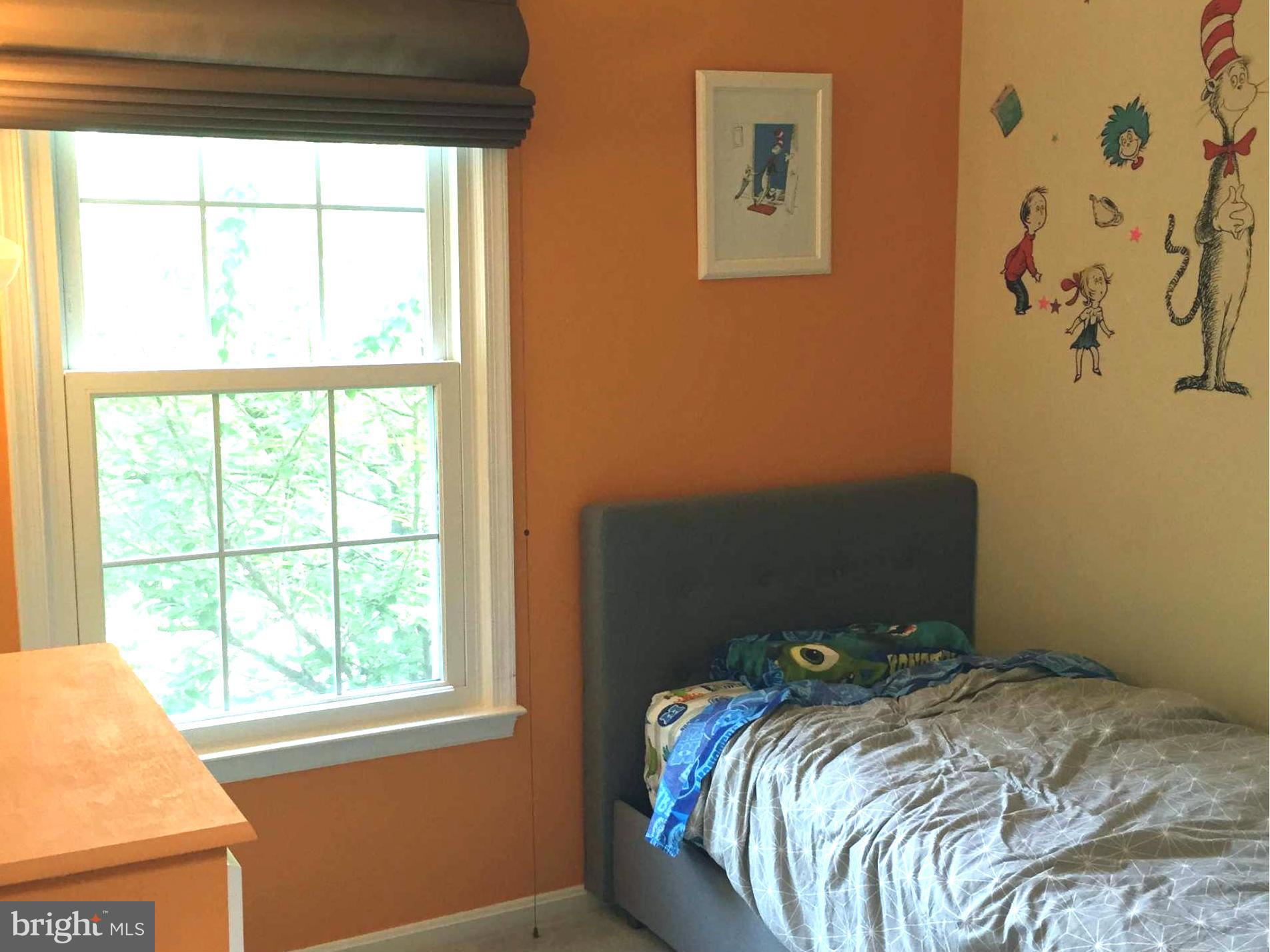 2617 Chivalry Court Silver Spring, MD 20902 - Photo 17 of 20 a bed sitting in a bedroom next to a window