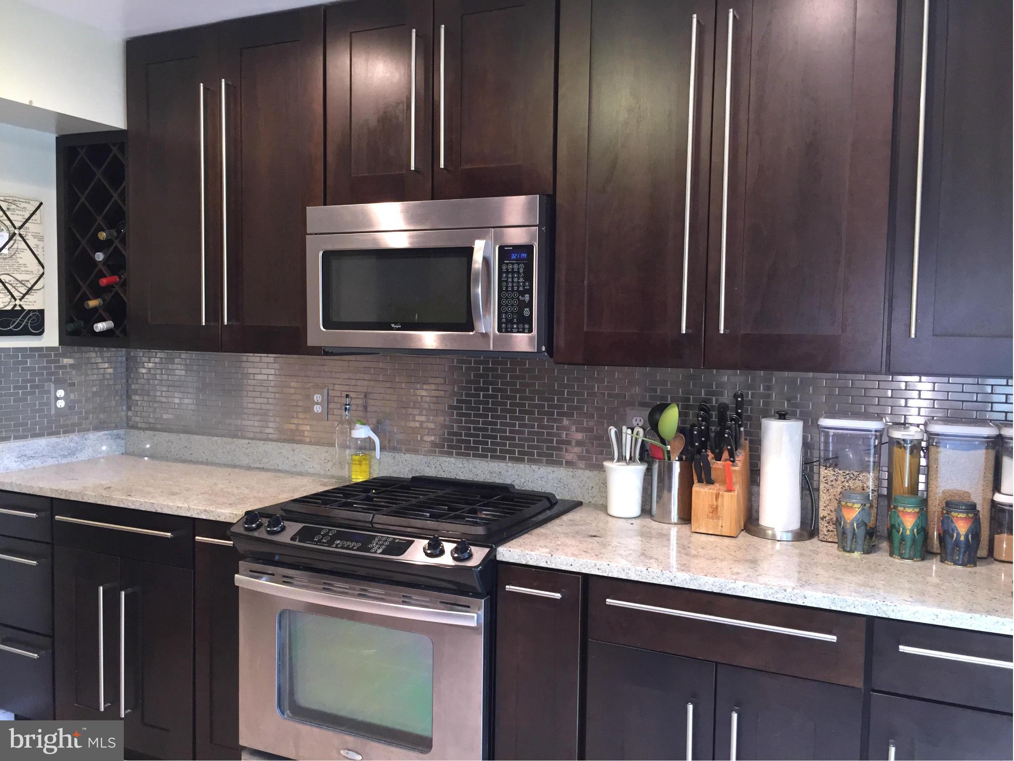 2617 Chivalry Court Silver Spring, MD 20902 - Photo 4 of 20 a kitchen with granite countertop stainless steel appliances and cabinets