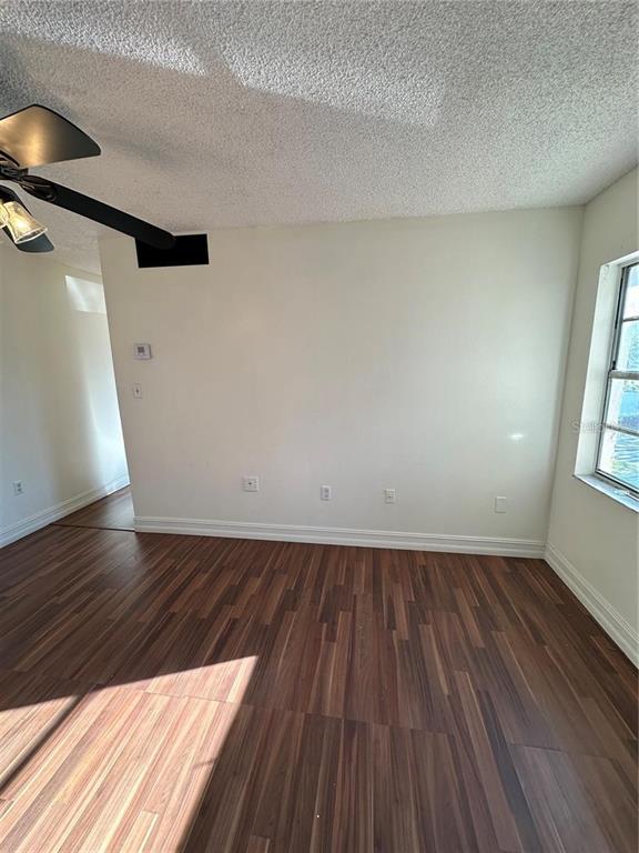 1918 Honour Road, Unit 4 Orlando, FL 32839 - Photo 3 of 17 a view of an empty room with wooden floor and a window