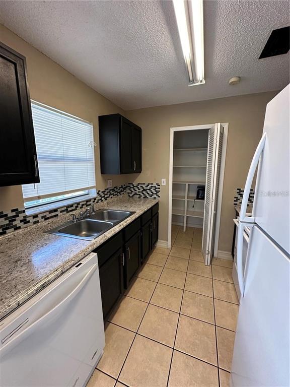 1918 Honour Road, Unit 4 Orlando, FL 32839 - Photo 4 of 17 a kitchen with a sink stove and refrigerator