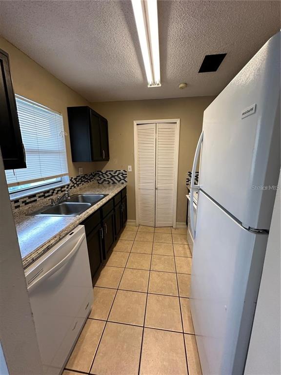 1918 Honour Road, Unit 4 Orlando, FL 32839 - Photo 5 of 17 a kitchen with a refrigerator and a stove
