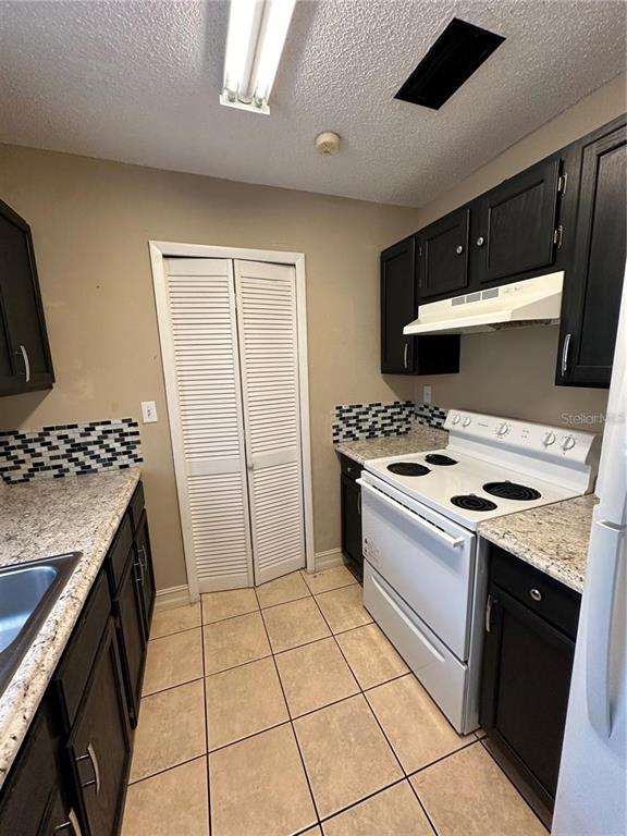 1918 Honour Road, Unit 4 Orlando, FL 32839 - Photo 6 of 17 a kitchen with a stove and a refrigerator