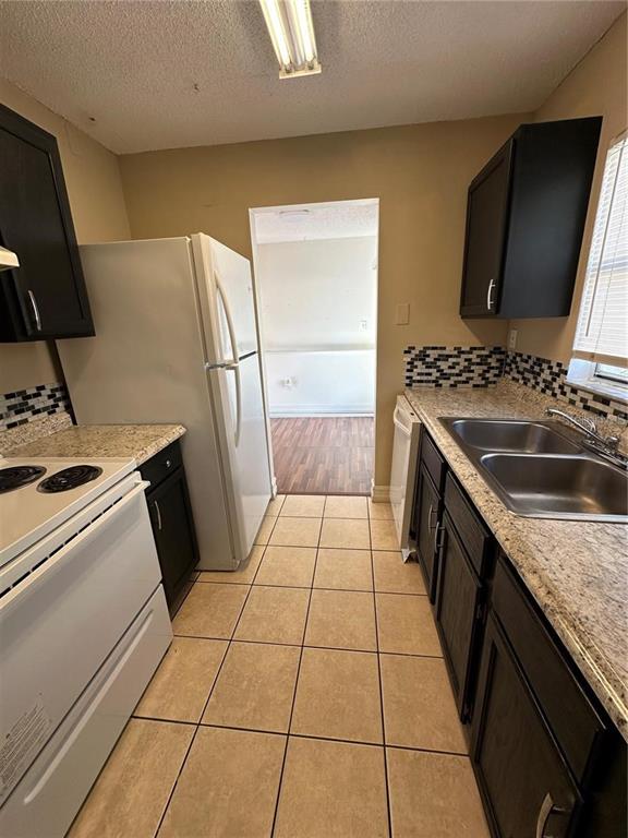 1918 Honour Road, Unit 4 Orlando, FL 32839 - Photo 7 of 17 a kitchen with a sink and a stove top oven