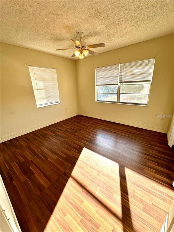 1918 Honour Road, Unit 4 Orlando, FL 32839 - Photo 8 of 17 a view of an empty room with wooden floor and a window