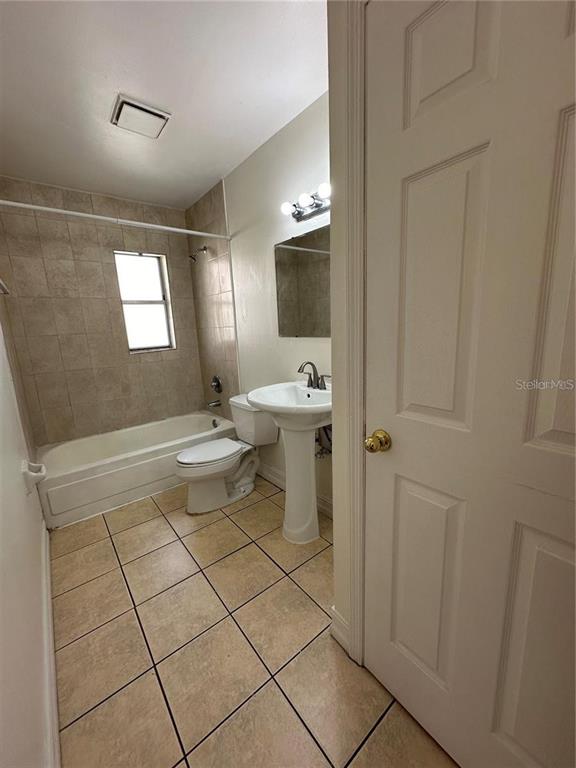 1918 Honour Road, Unit 4 Orlando, FL 32839 - Photo 10 of 17 a bathroom with a sink toilet and mirror