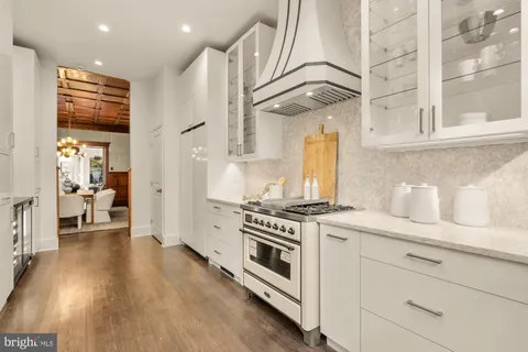 a kitchen with stainless steel appliances granite countertop a stove and a refrigerator