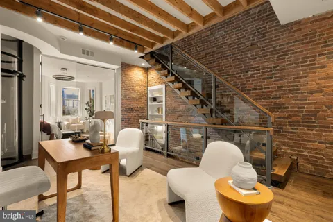 a living room with furniture and a mirror