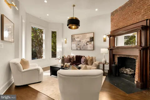 a living room with furniture a window and a fireplace