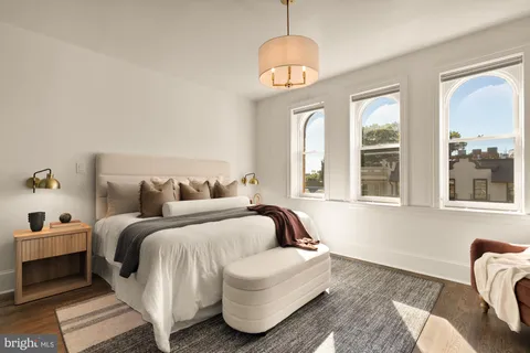 a bedroom with furniture and a fireplace