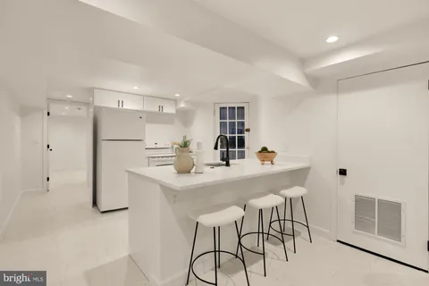 a kitchen with sink and mirror