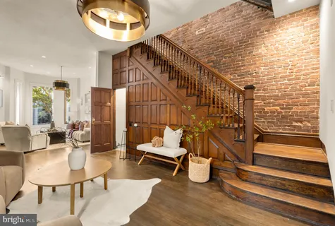 a balcony with chairs and wooden floor