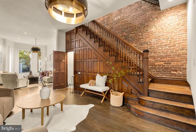 a balcony with chairs and wooden floor