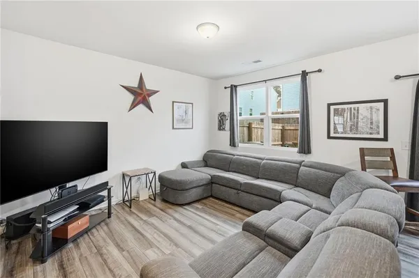 a living room with stainless steel appliances granite countertop furniture and a kitchen view