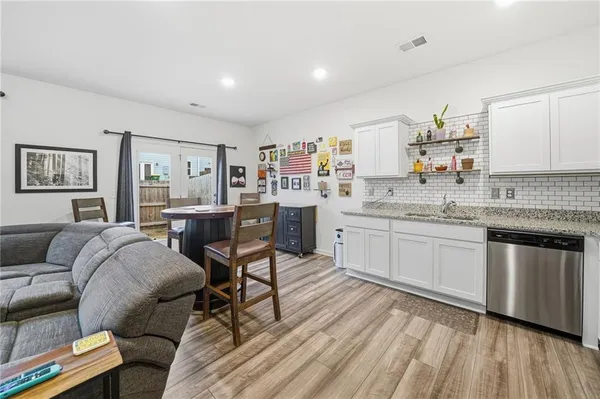 a kitchen with stainless steel appliances granite countertop a stove microwave and cabinets