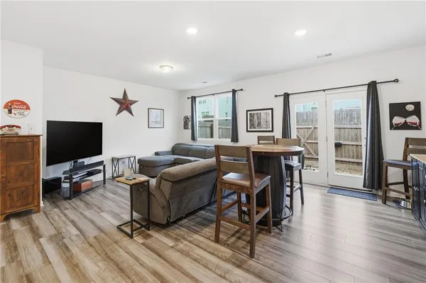 a living room with furniture and a wooden floor