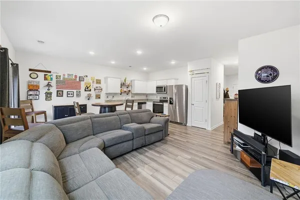 a living room with furniture and a flat screen tv