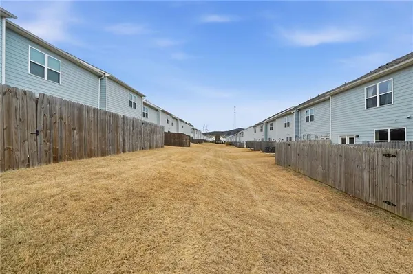 a view of a house with wooden fence