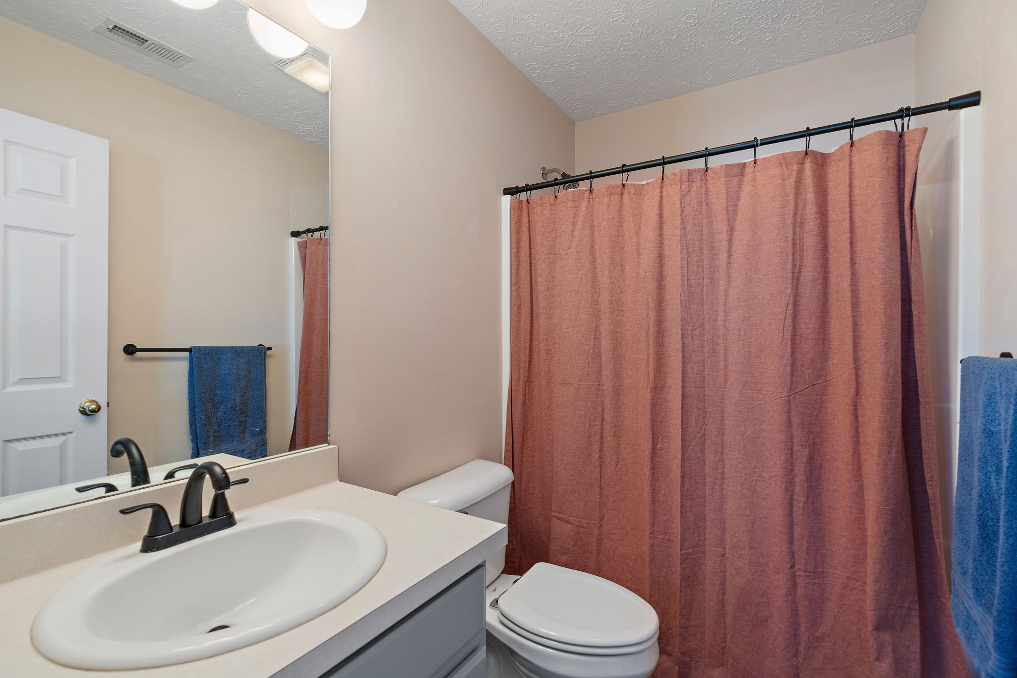 415 Shadow Glen Drive Nashville, TN 37211 - Photo 25 of 27 a bathroom with a sink a toilet and shower curtain