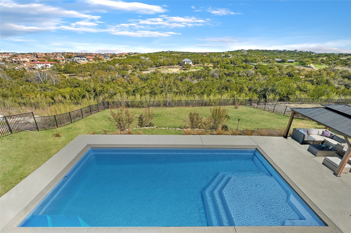 A resort-style backyard with a SPARKLING POOL, cabana, and breezy views. All of this in the HEART of Lake Travis and just minutes from all of the conveniences it has to offer with a LOW TAX RATE.