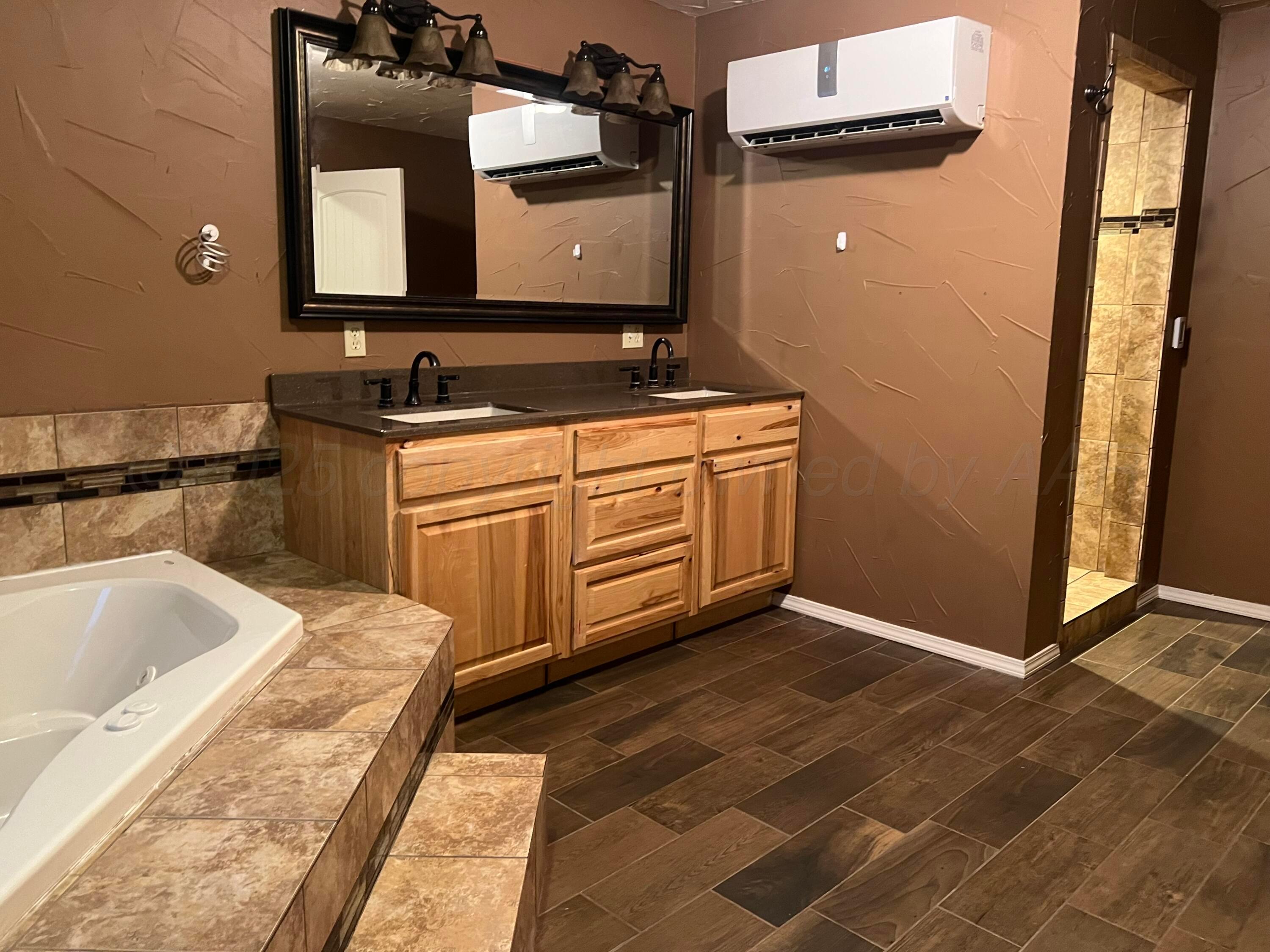 505 South Denton Street Booker, TX 79005 - Photo 10 of 15 a bathroom with a sink and a bathtub