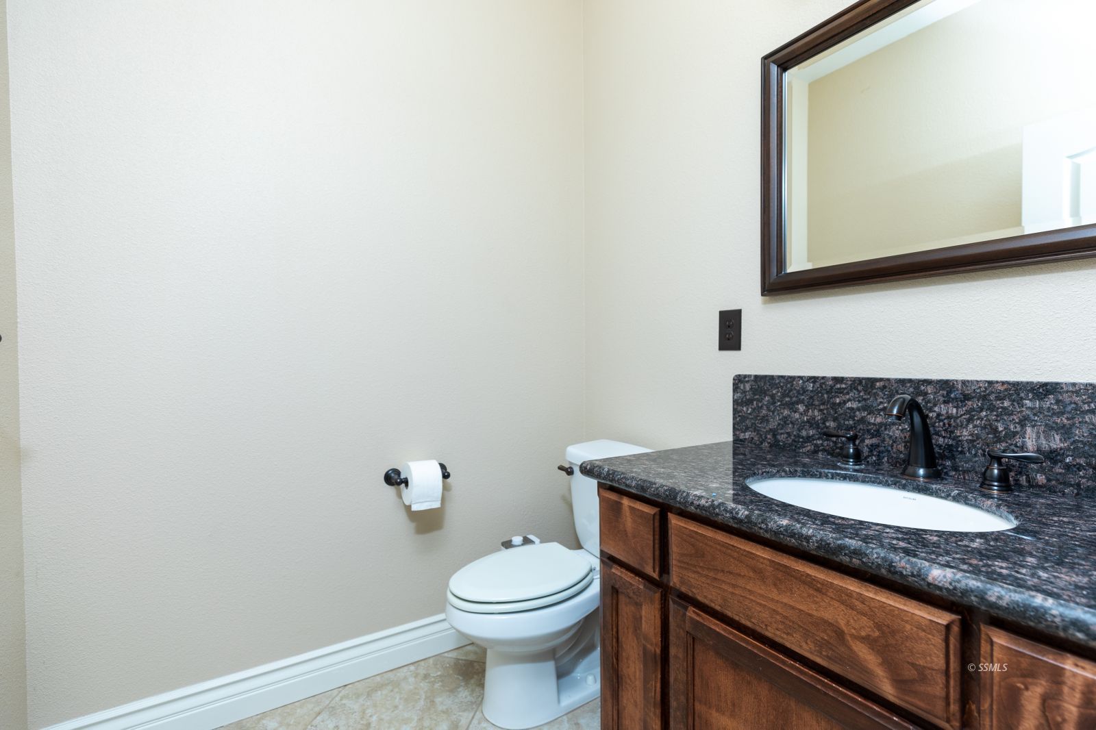 404 Christopher Court Ridgecrest, CA 93555 - Photo 13 of 31 a bathroom with a granite countertop toilet a sink and mirror