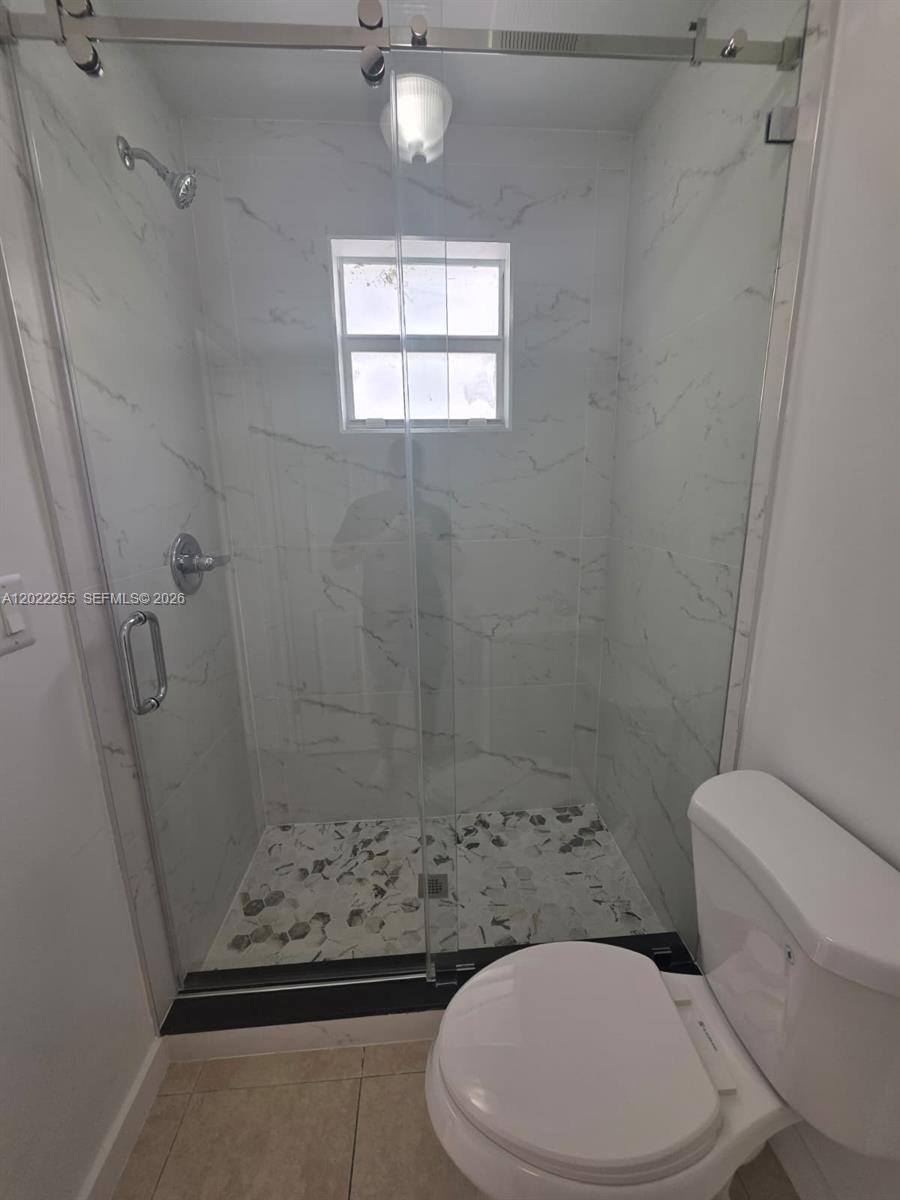 829 Southwest 3rd Street, Unit 831 Miami, FL 33130 - Photo 7 of 21 a bathroom with a toilet and a shower