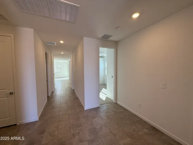 a view of a hallway with wooden shelves