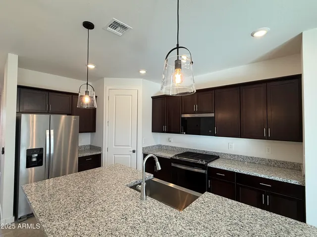 a kitchen with a refrigerator and a sink