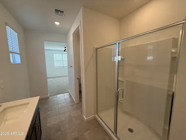 a bathroom with a shower and a sink
