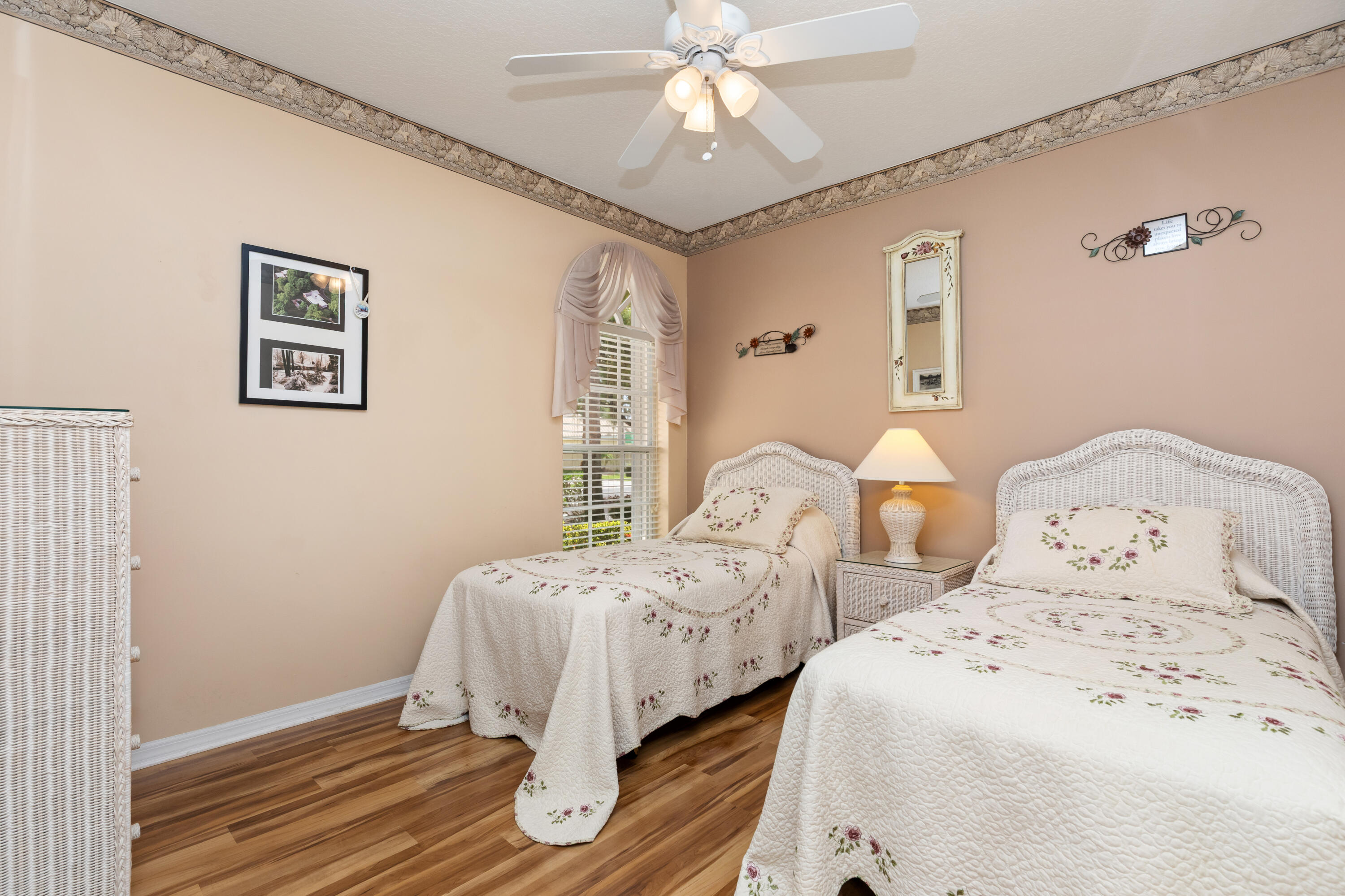 6698 Vía Roma Delray Beach, FL 33446 - Photo 18 of 50 a bedroom with two beds and a chandelier