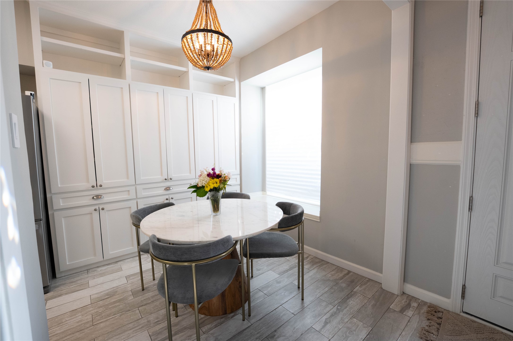 7447 Brompton Street, Unit 7447 Houston, TX 77025 - Photo 9 of 27 Charming eat-in kitchen featuring a sunny bay window and built-in bench seating and lot of custom cabinets for storage.