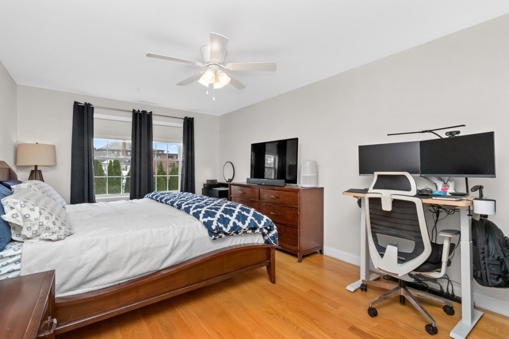 29 Spruce Street, Unit 23 Waltham, MA 02453 - Photo 13 of 26 a bedroom with a bed and a flat screen tv