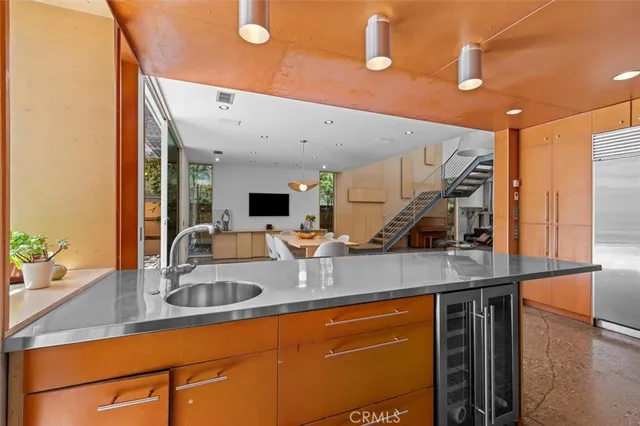 a kitchen with stainless steel appliances granite countertop a sink and a refrigerator
