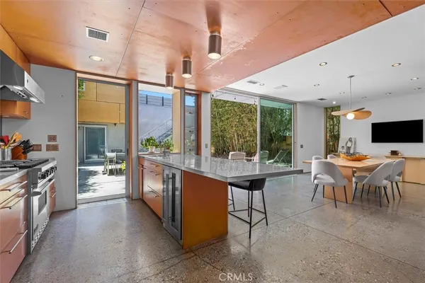 a large kitchen with a table and chairs