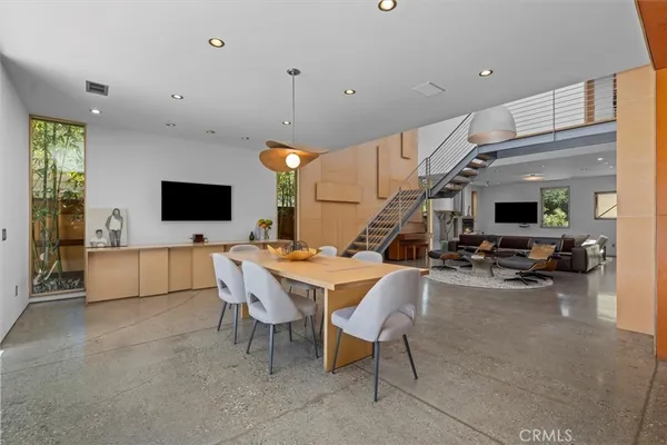 a view of a livingroom with furniture and a flat screen tv