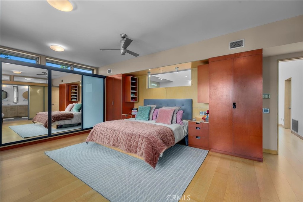 604 33rd Street Manhattan Beach, CA 90266 - Photo 24 of 46 a bedroom with a large bed and a chandelier