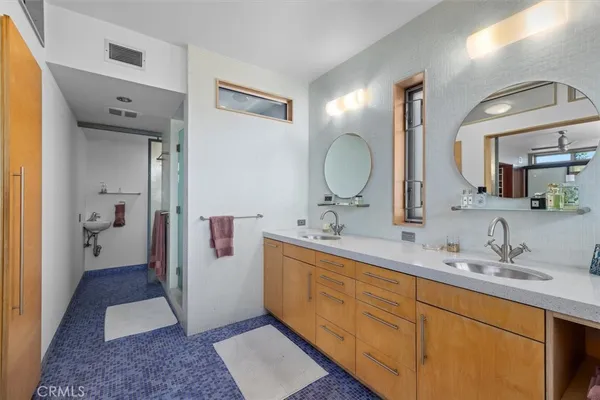 a spacious bathroom with a double vanity sink and a mirror