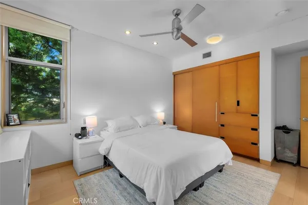 a bedroom with a bed and a window