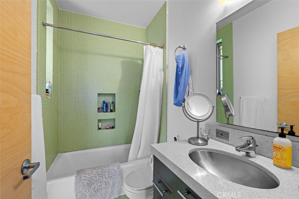 604 33rd Street Manhattan Beach, CA 90266 - Photo 36 of 46 a bathroom with a granite countertop sink a toilet and a mirror