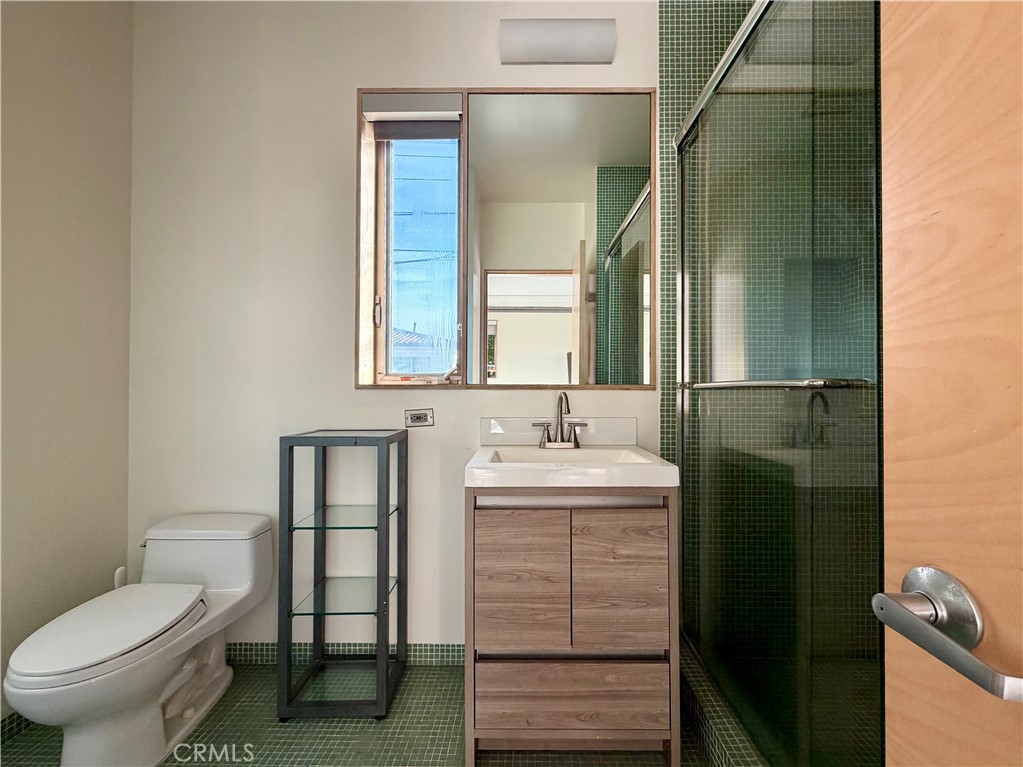 604 33rd Street Manhattan Beach, CA 90266 - Photo 46 of 46 a bathroom with a toilet sink and mirror
