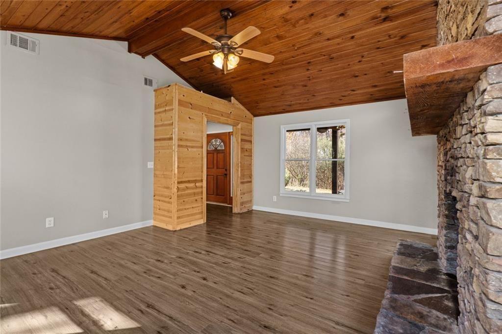 345 Roland Drive Canton, GA 30114 - Photo 23 of 44 a view of an empty room with a window and wooden floor