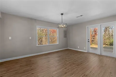 a room with stainless steel appliances wooden floors and view living room
